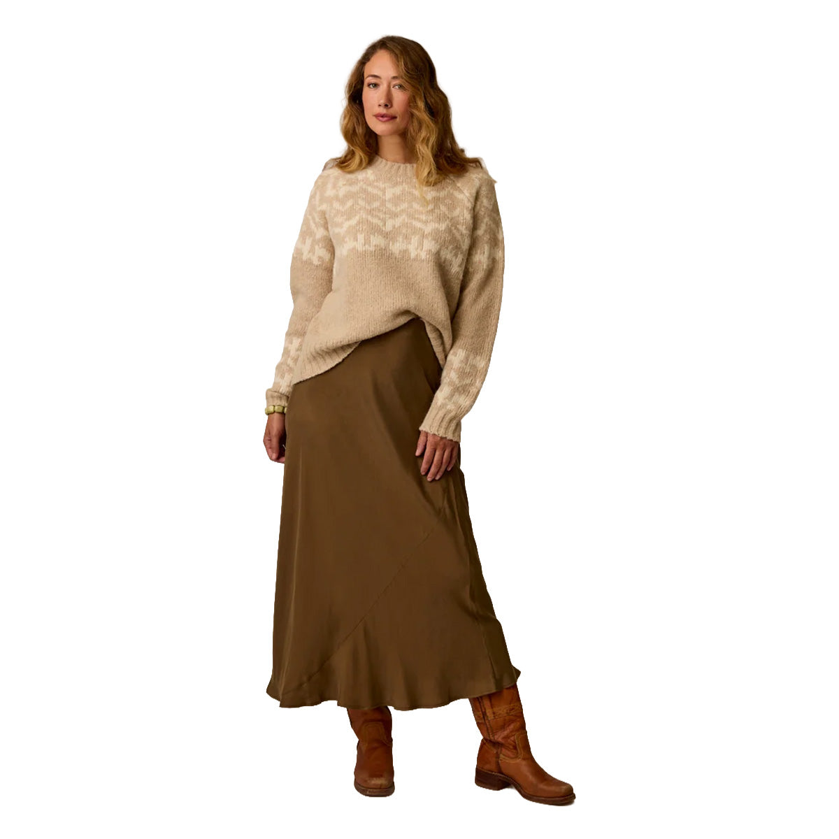 Women's oversized fairisle pullover sweater in cream and beige chevron pattern, worn with midi skirt and boots