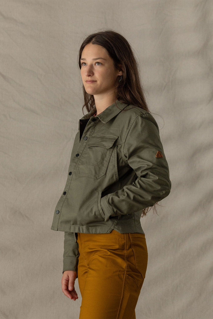 Women's button-front olive jacket with chest pockets and sleeve patch, side view