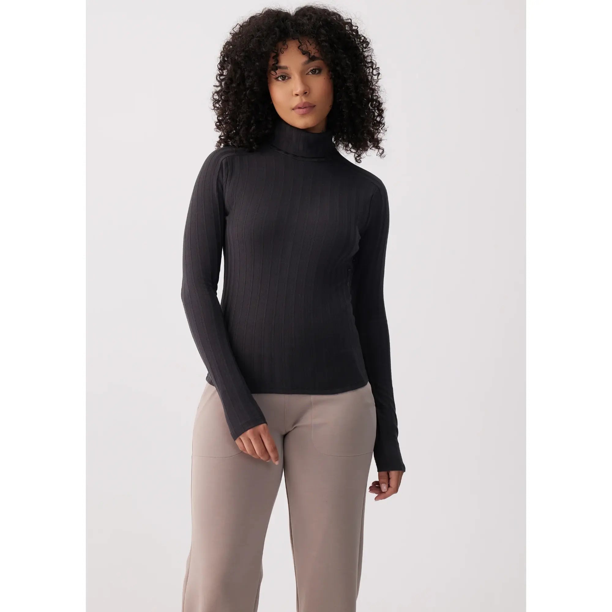 Black ribbed turtleneck long-sleeve top with thumbholes, front on-model view