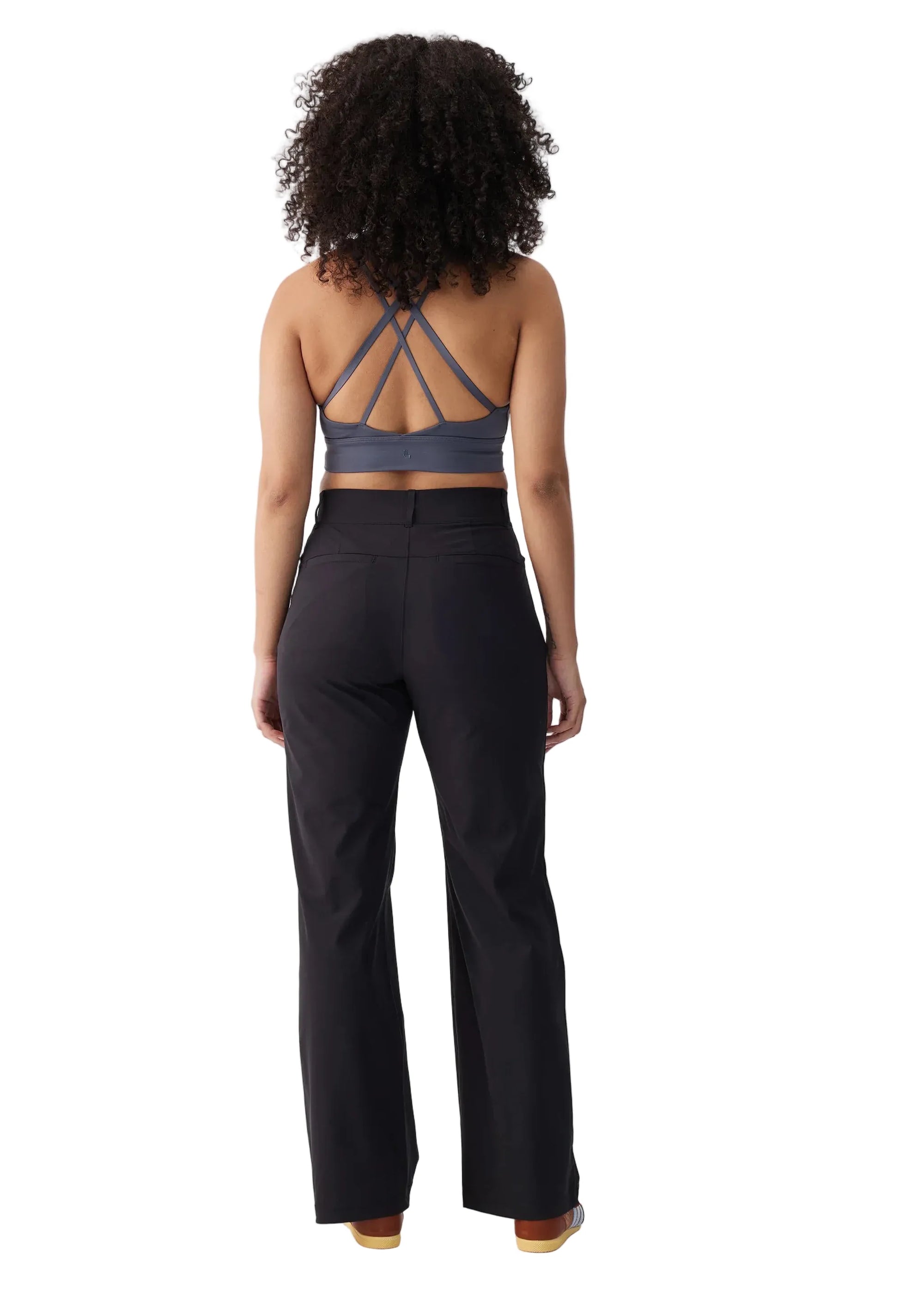 Women's wide-leg travel trousers in black, back view on model with sports bra