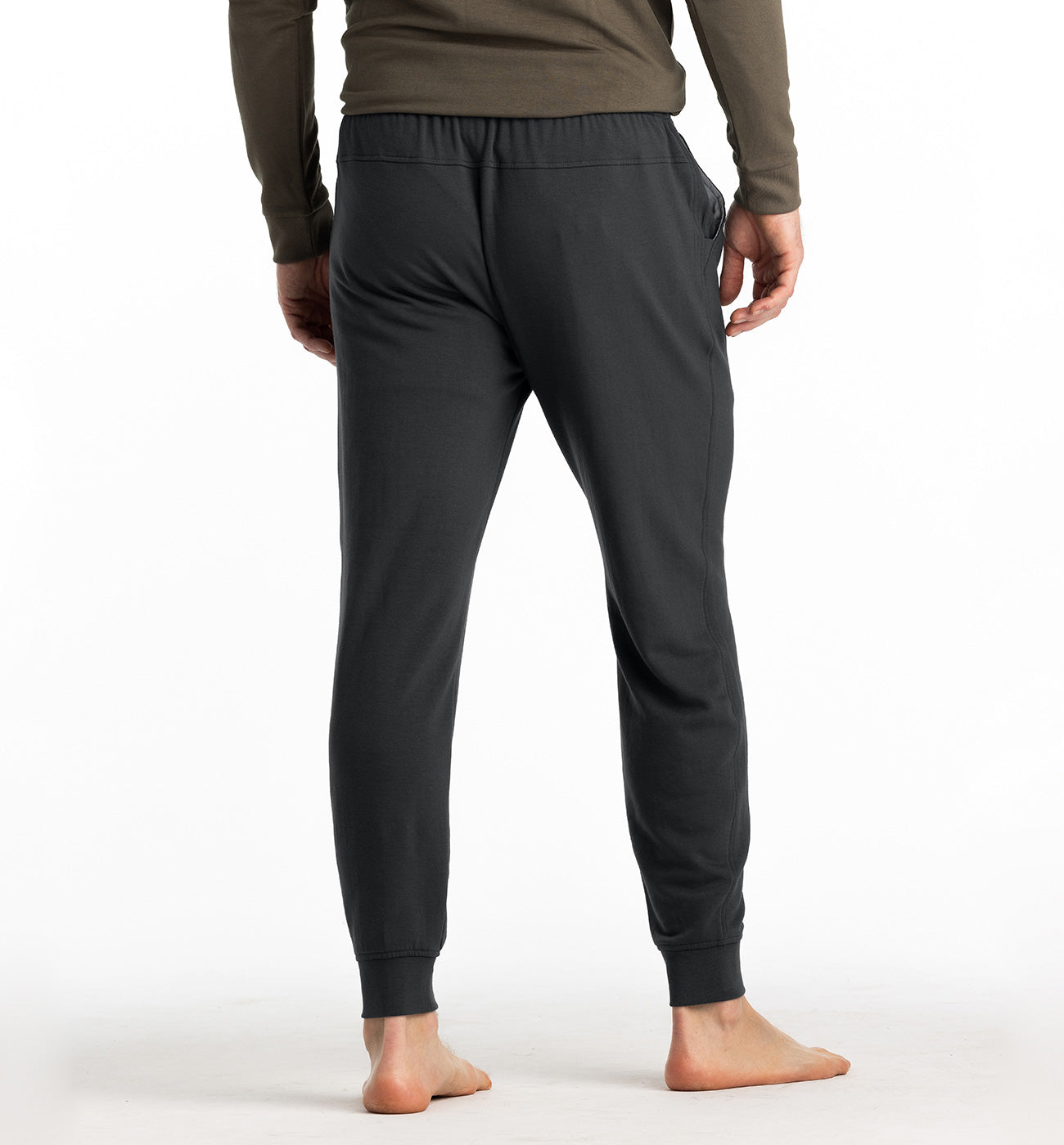 Men's slim-fit jogger pants in dark charcoal, back view, with ribbed cuffs and elastic waistband