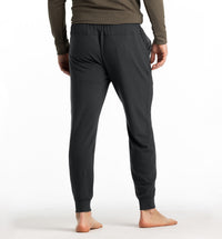 Men's slim-fit jogger pants in dark charcoal, back view, with ribbed cuffs and elastic waistband