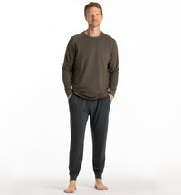 Men's lightweight fleece jogger pants in dark charcoal, full-length front view on model