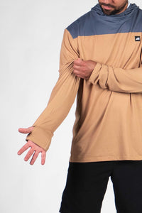 Color-blocked hooded sweatshirt with blue hood and tan body, thumbholes visible on extended sleeves