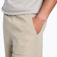 Light beige athletic shorts with side pockets, detail view showing pocket construction