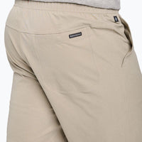 Light tan outdoor shorts with elastic waistband and back pocket, side view