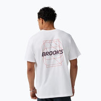 Men's white graphic t-shirt shown from back with geometric logo print, worn by male model