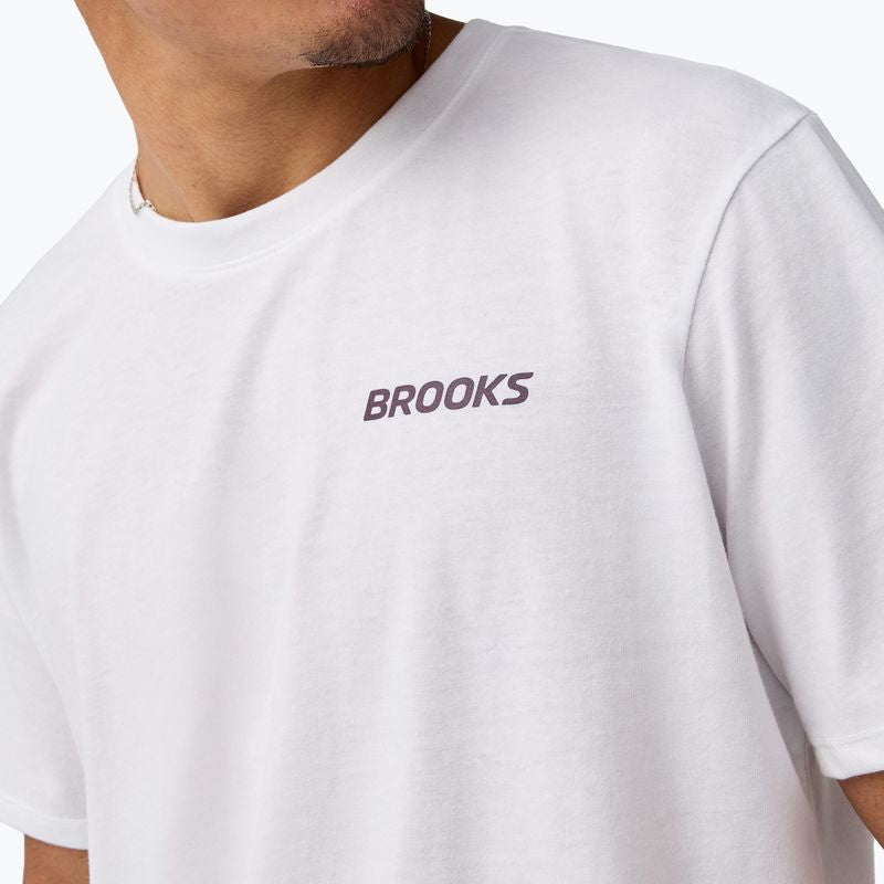White men's short sleeve graphic tee with small logo on chest, close-up front view