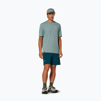 Teal athletic shorts worn by male model in studio setting, front view