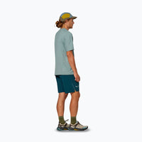 Teal athletic shorts worn by man in profile view with hiking boots
