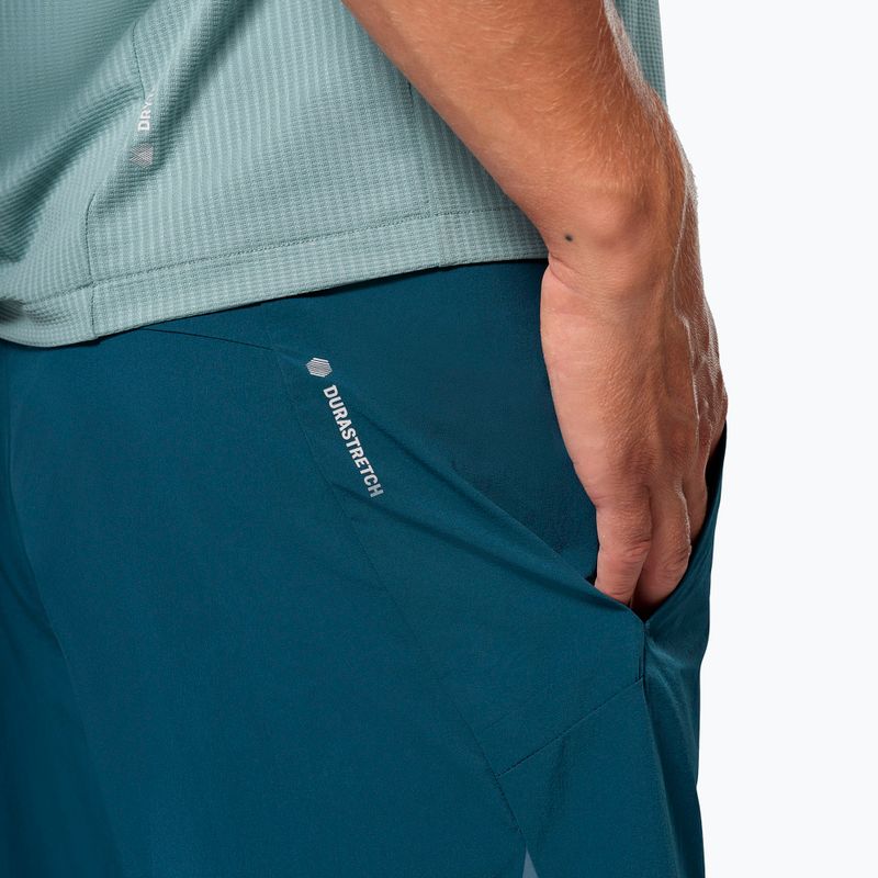 Teal athletic shorts with side pocket and white logo text on thigh