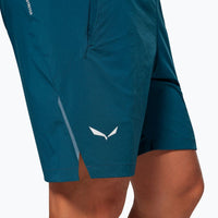 Teal athletic shorts with white logo, showing partial leg view and side detail