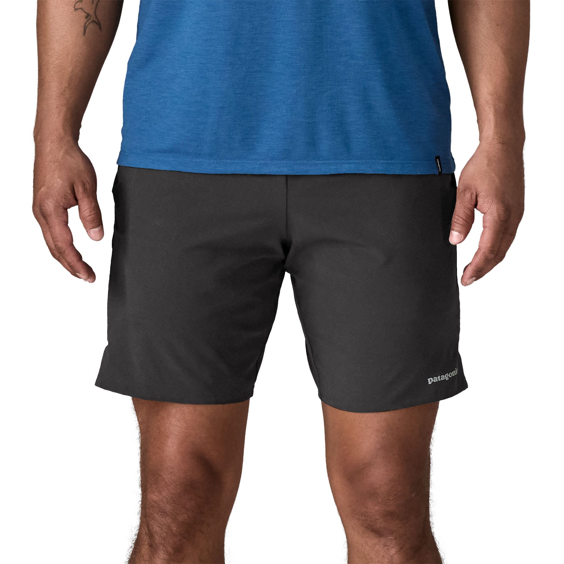 Black athletic shorts worn by man, front view showing mid-thigh length and fitted waistband