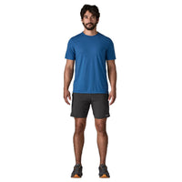 Dark athletic shorts with elastic waistband worn by man in studio photo