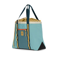 Large utility tote bag with drawstring top, front zip pocket, and carrying handles