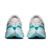 Rear view of women's running shoes with white upper and teal aquamarine chunky midsole