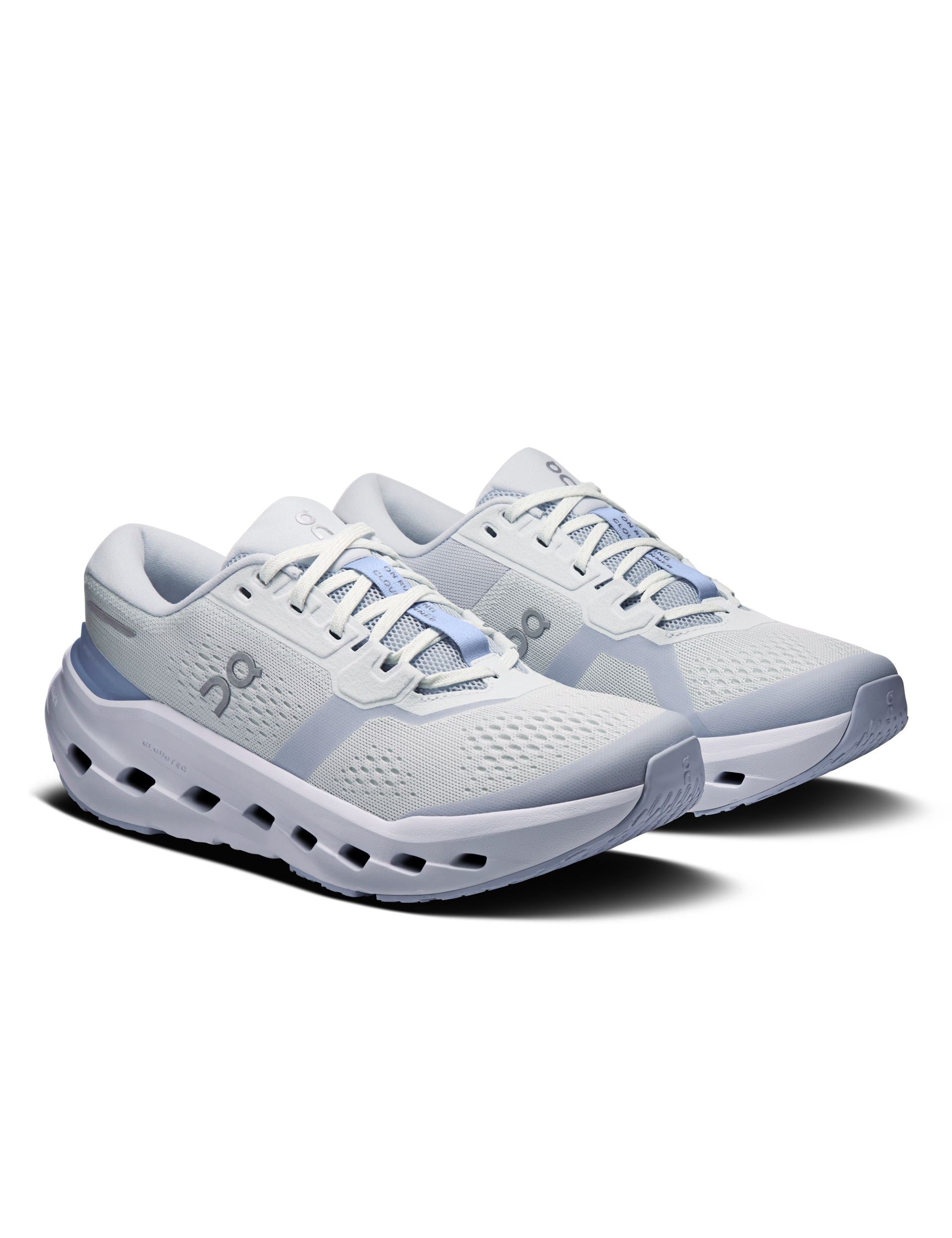 Women's running shoes in white and light blue, three-quarter view, chunky cloud sole
