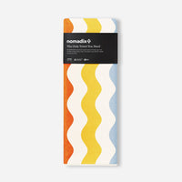 Rectangular towel with colorful wavy stripe pattern in packaging on white background