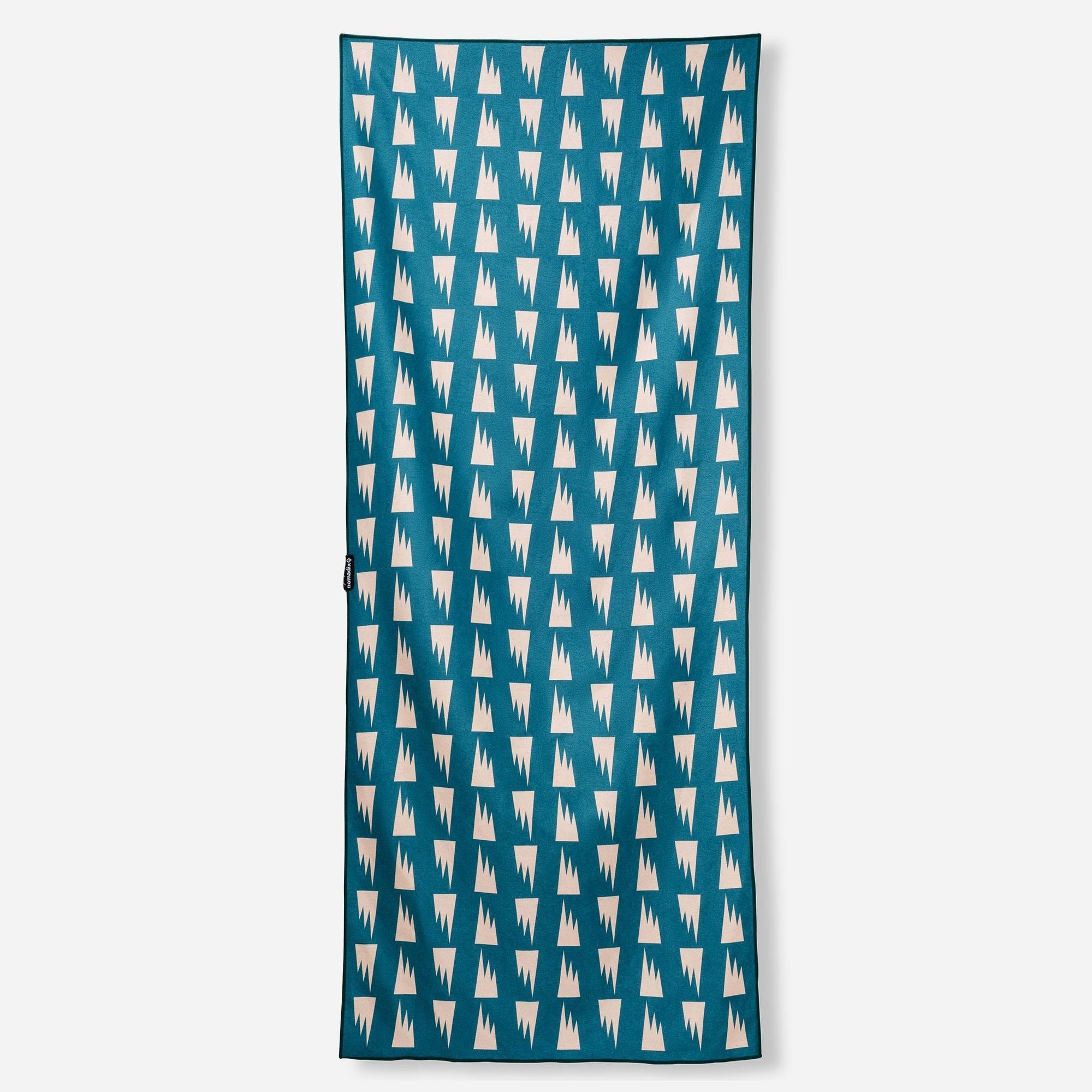 Rectangular towel with teal background and repeating white geometric tooth pattern
