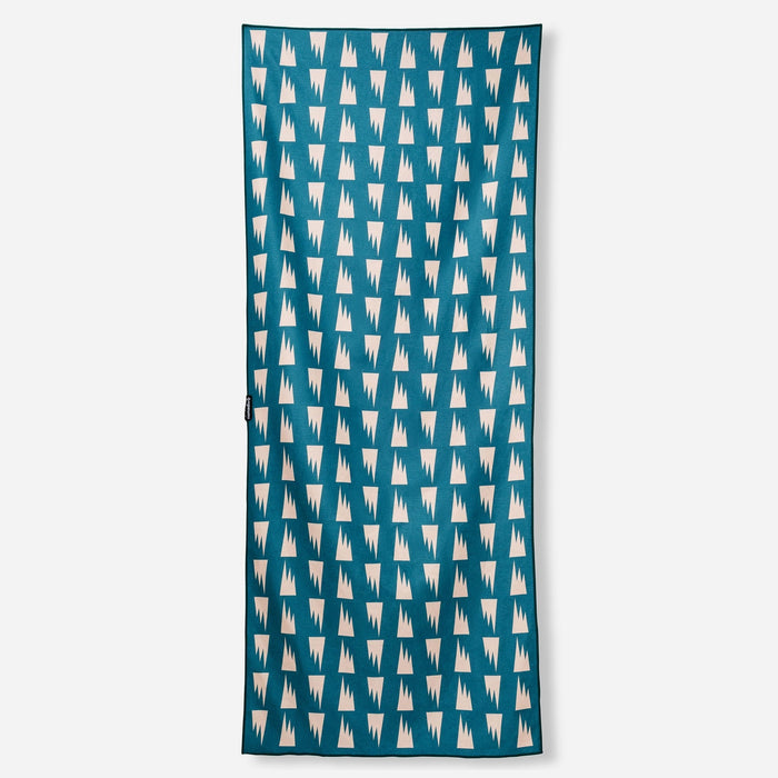 Rectangular towel with teal background and repeating white geometric tooth pattern