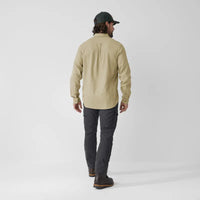 Light beige long-sleeve travel shirt shown from back view on male model