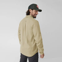Light beige long-sleeve button-up shirt worn by male model, back three-quarter view