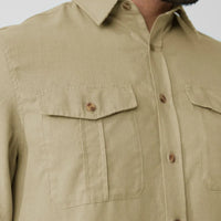 Beige long-sleeve travel shirt with chest pockets and button closure, detail view