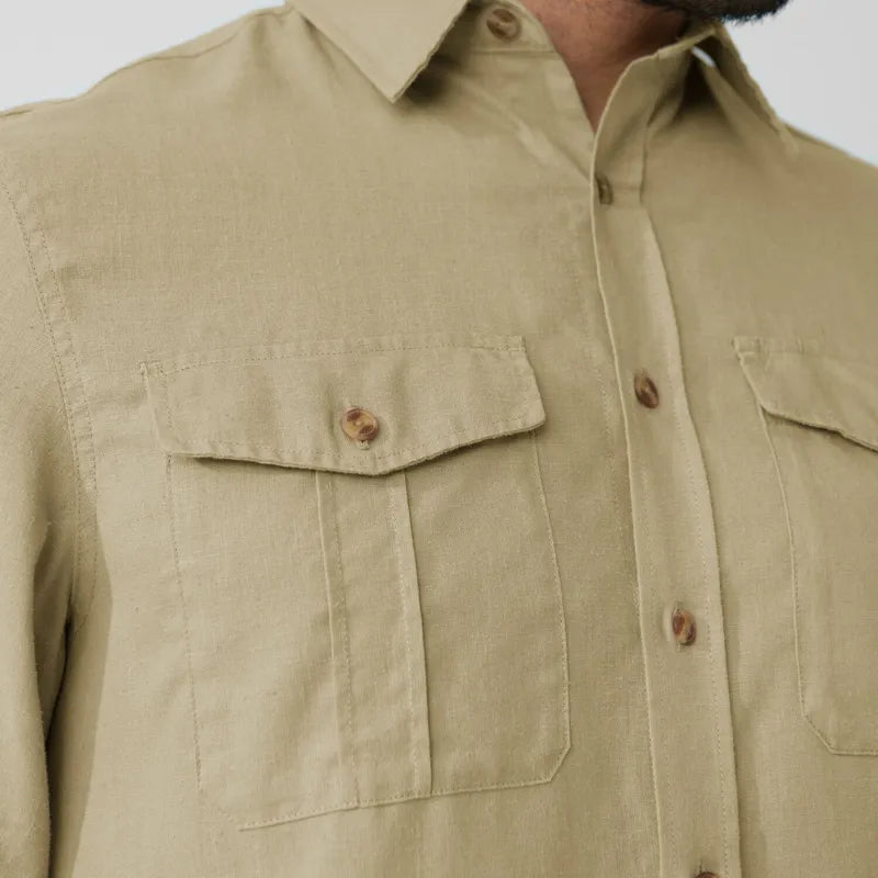 Beige long-sleeve travel shirt with chest pockets and button closure, detail view