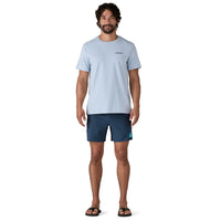 Dark navy blue men's swim shorts with side logo, worn by model standing front view