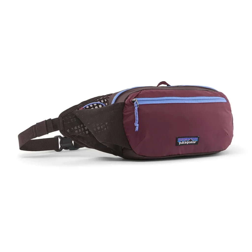 Hip pack fanny bag in dark plum with light blue zipper, mesh side panel, and adjustable strap