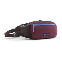 Hip pack fanny bag in dark plum with light blue zipper, mesh side panel, and adjustable strap