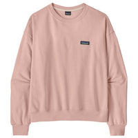 Soft pink crewneck sweatshirt with ribbed cuffs and hem, small logo patch on chest