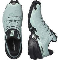 Trail running shoe shown from top and side angles, featuring aggressive lugged outsole and lace system