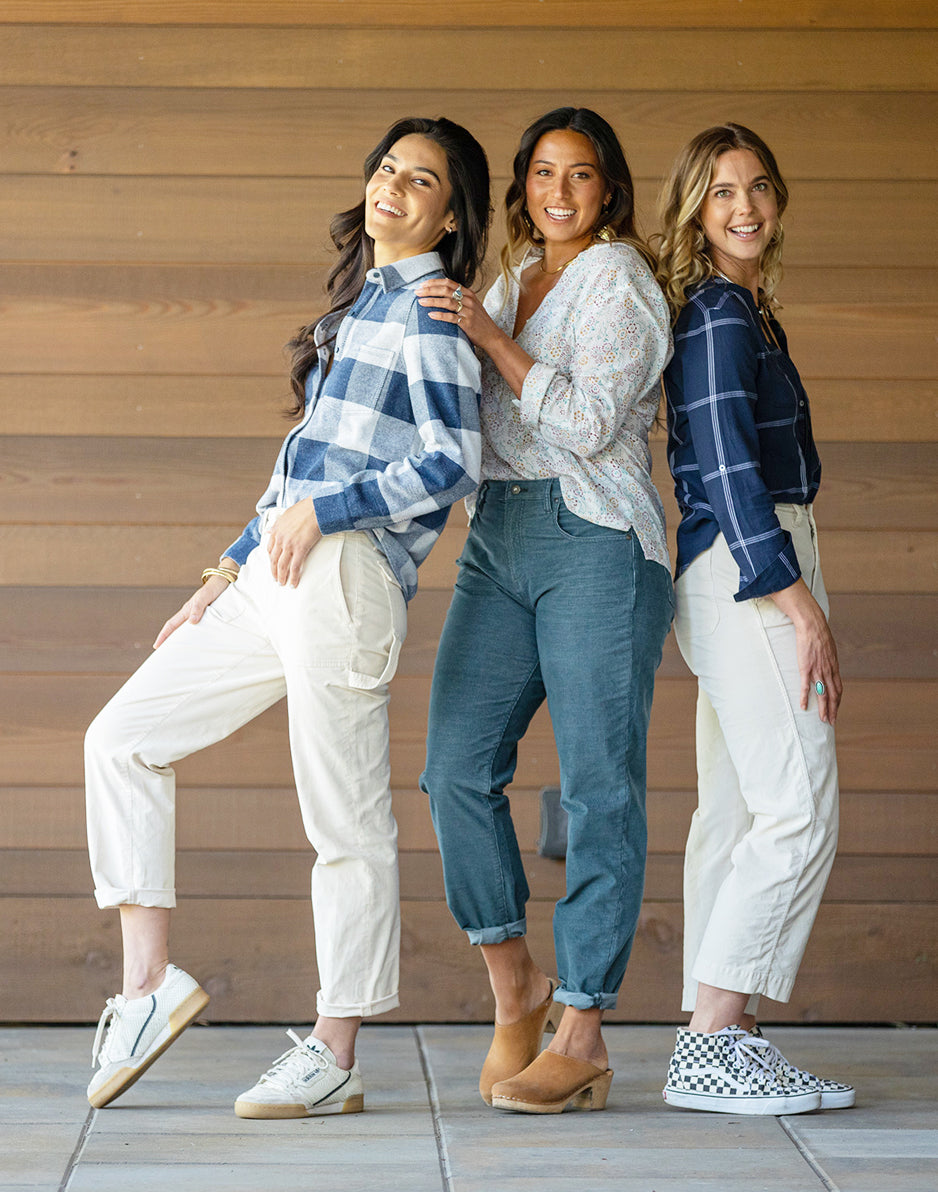 Women's plaid button-up shirt in navy buffalo check, worn open over white top, on model