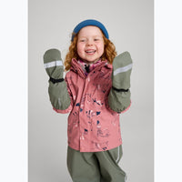 Child wearing pink printed rain jacket with green sleeves, matching mittens and blue beanie, arms raised