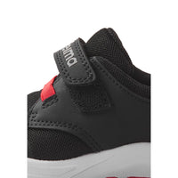 Black children's sneaker with velcro strap and mesh details, side view closeup