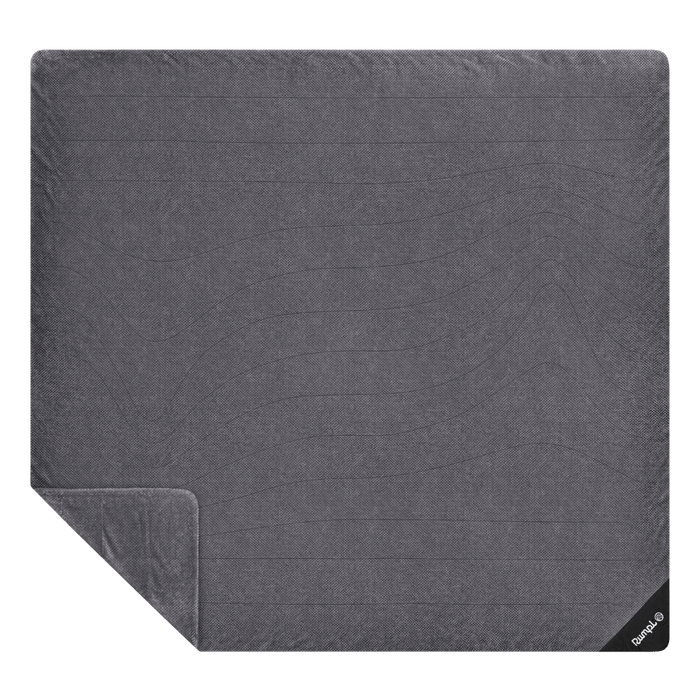 Large two-person fleece blanket laid flat, showing quilted horizontal stitching and folded corner