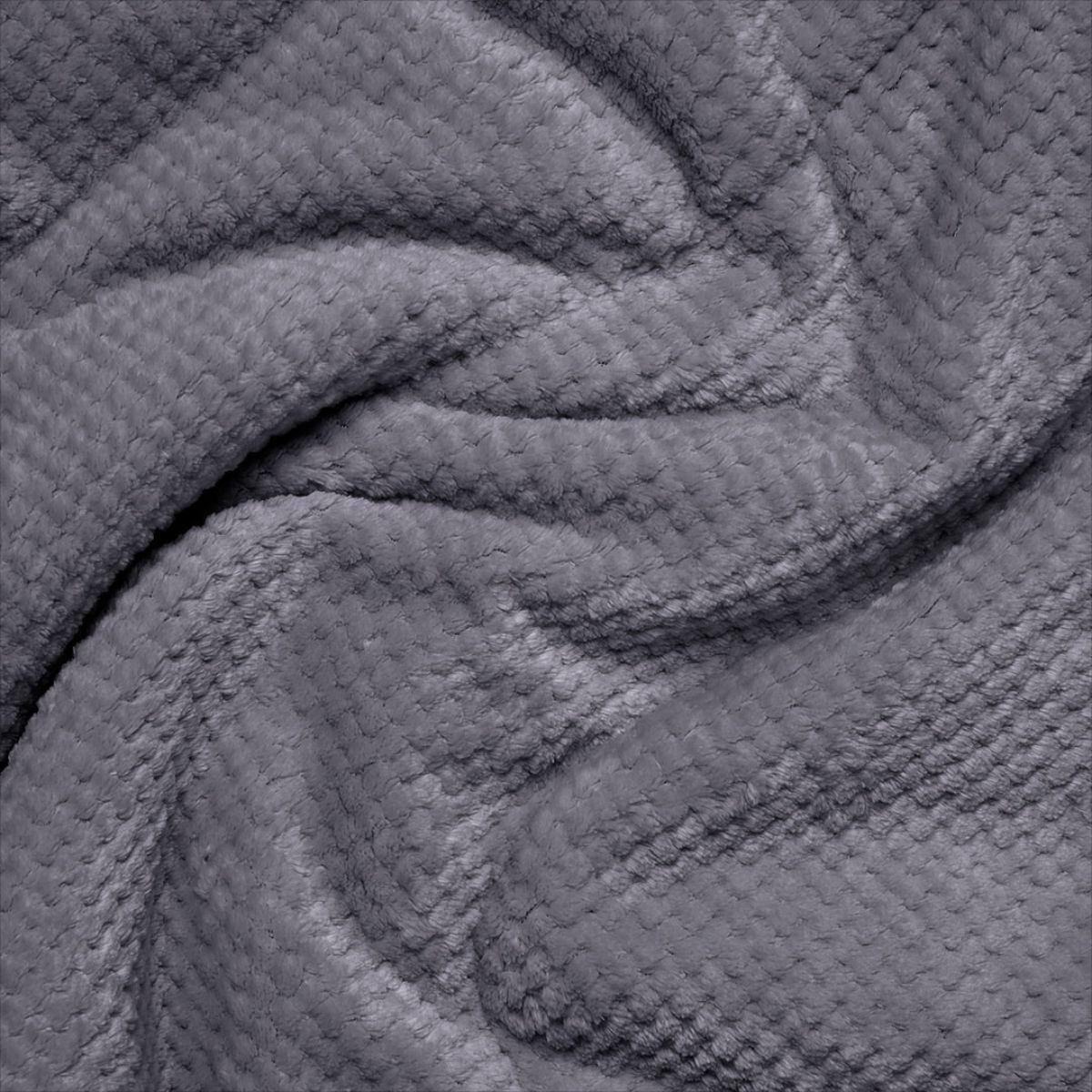 Close-up detail of a soft textured fleece blanket with waffle-knit pattern in dark grey