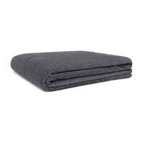 Folded large two-person fleece blanket in dark grey with textured waffle weave pattern