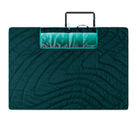 Large quilted outdoor mat in teal green with curved wave pattern and carry handle
