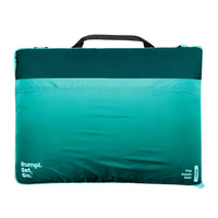 Rectangular outdoor mat with gradient teal to turquoise color and black carry handle