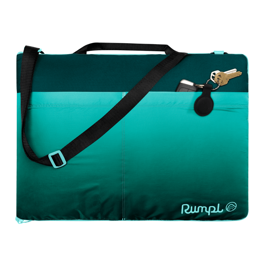 Teal gradient outdoor mat with black shoulder strap and carabiner clip attached