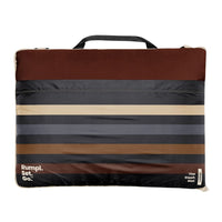 Striped outdoor mat with carrying handle in brown gray and cream tones