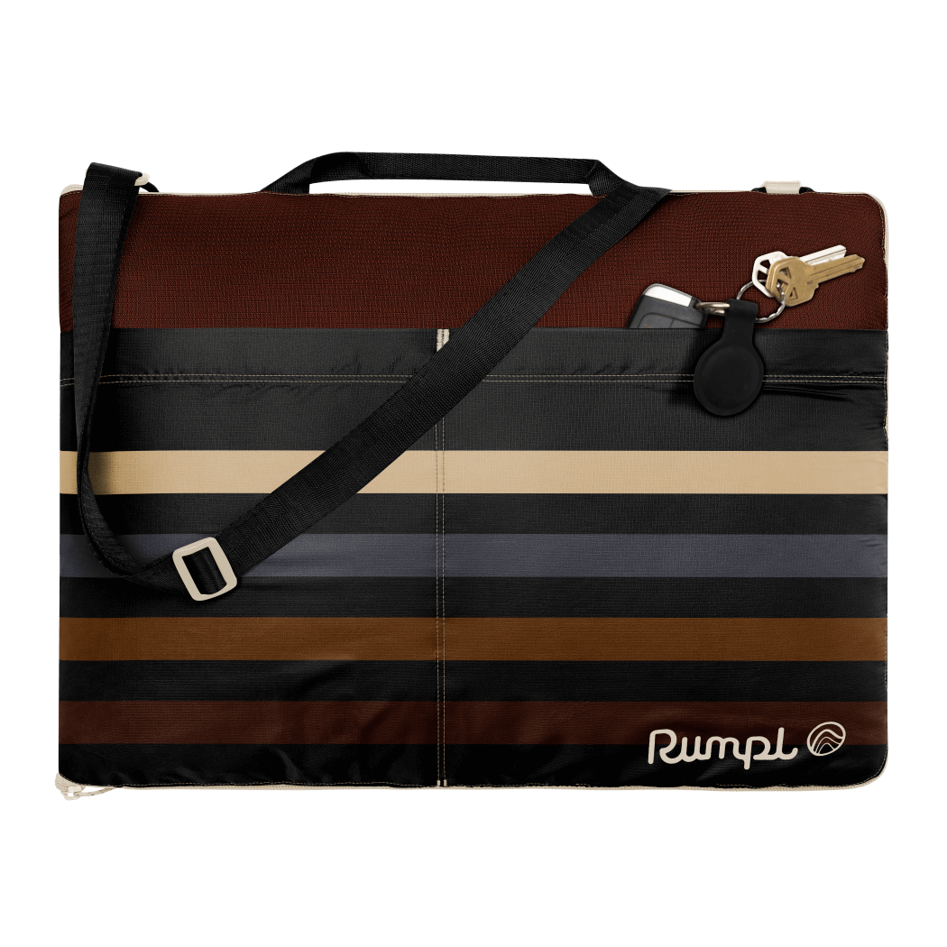 Striped blanket mat with shoulder strap and handle, featuring brown and neutral tones