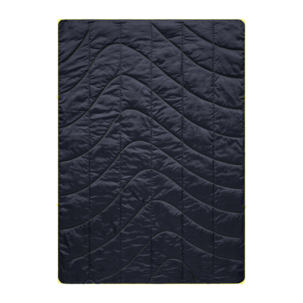 Dark blue quilted camping blanket with curved wave pattern stitching, flat overhead view