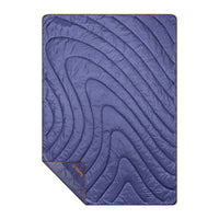 Purple quilted puffy blanket with curved stitching pattern laid flat, showing full rectangular shape
