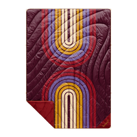 Quilted puffy blanket with retro rainbow arch pattern in burgundy, gold, and lavender, flat lay view