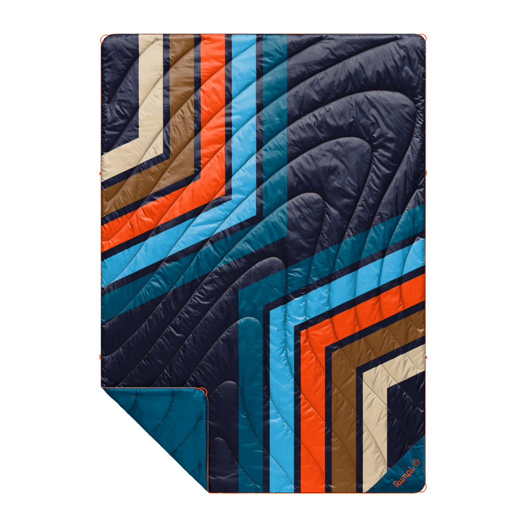 Quilted puffy blanket with bold retro geometric stripe pattern in navy, orange, blue, and brown