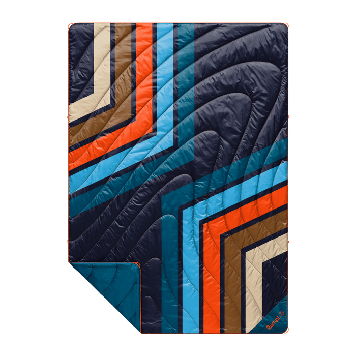 Quilted puffy blanket with bold retro geometric stripe pattern in navy, orange, blue, and brown