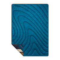Quilted puffy blanket in teal blue with swirling stripe pattern, corner folded to show reverse side